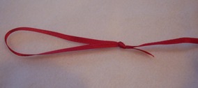 make a hanging loop by knotting the ribbon